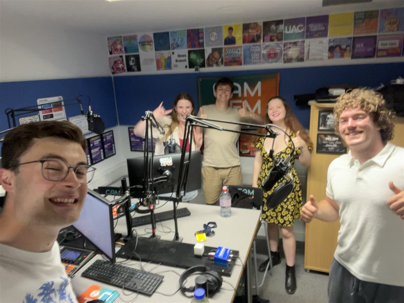Patrick and four other CamFM presenters posing together in the studio