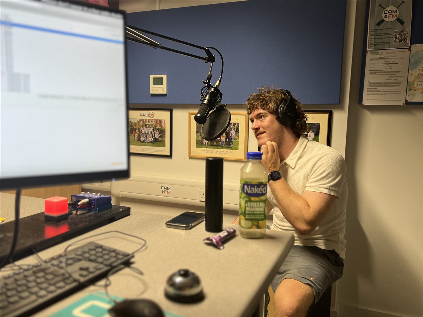 Patrick on air in the CamFM studio, on-air light lit behind him