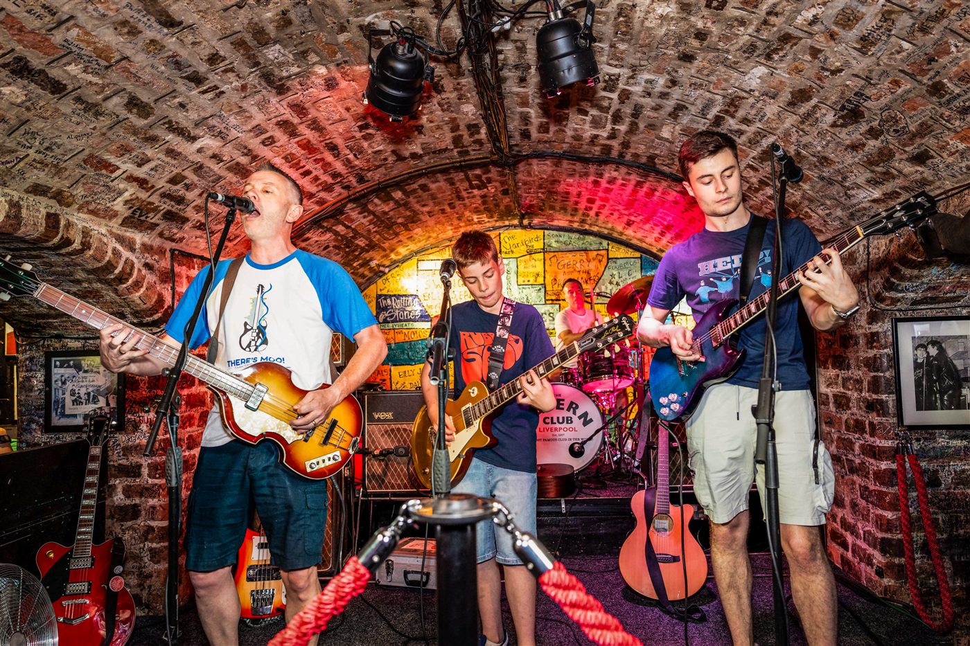 Patrick playing bass on stage with his band at a Liverpool venue