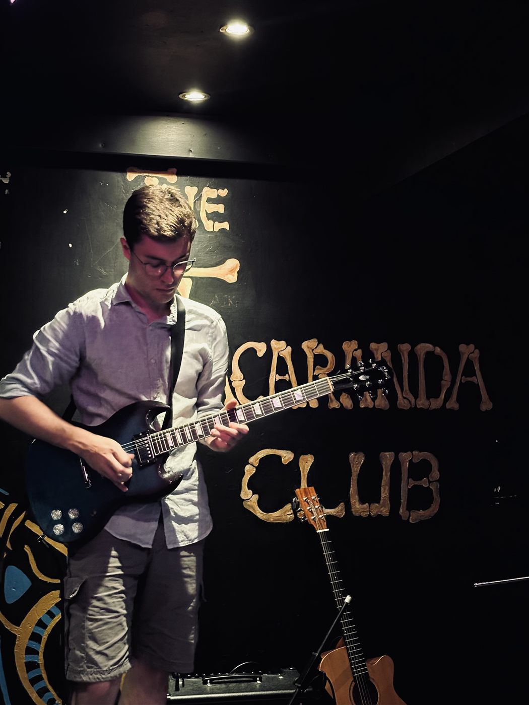 Patrick playing guitar on stage